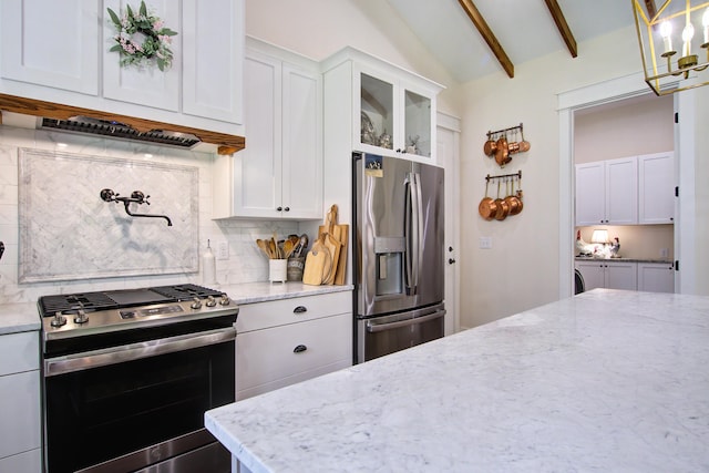 105 Bobcat Ln, Ravenel, SC 29470 - kitchen with stainless steel appliances, decorative backsplash, light stone counters, glass insert cabinets, and white cabinets