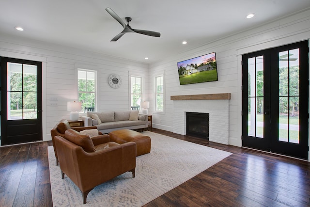105 Bobcat Ln, Ravenel, SC 29470 - living room featuring dark wood-style flooring, french doors, a fireplace, a ceiling fan, and recessed lighting