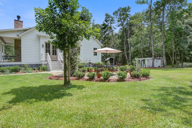 105 Bobcat Ln, Ravenel, SC 29470 - view of green lawn featuring a patio and an outdoor structure