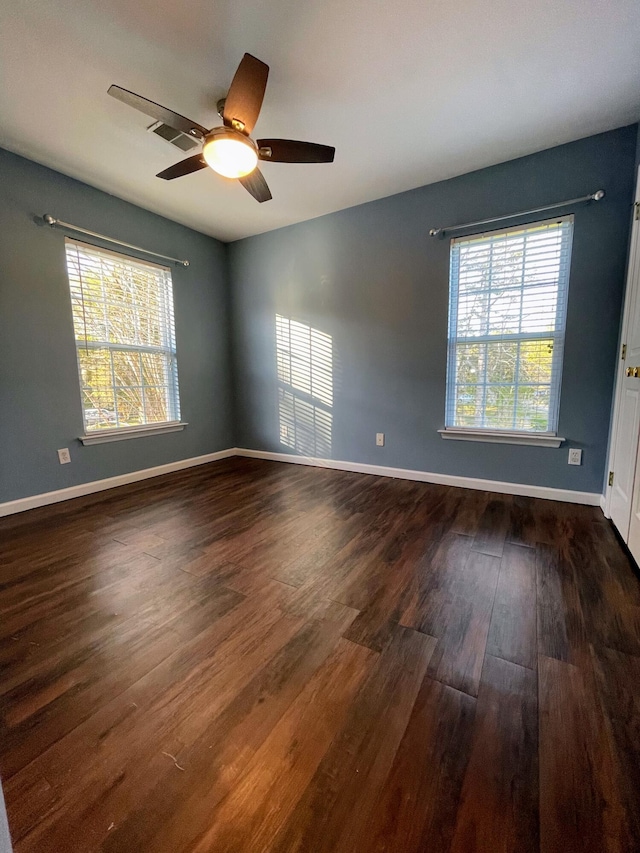 spare room with ceiling fan and dark hardwood / wood-style floors