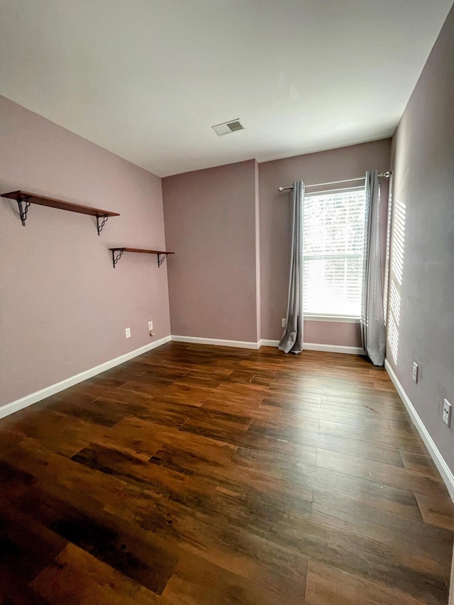 empty room featuring dark wood-type flooring