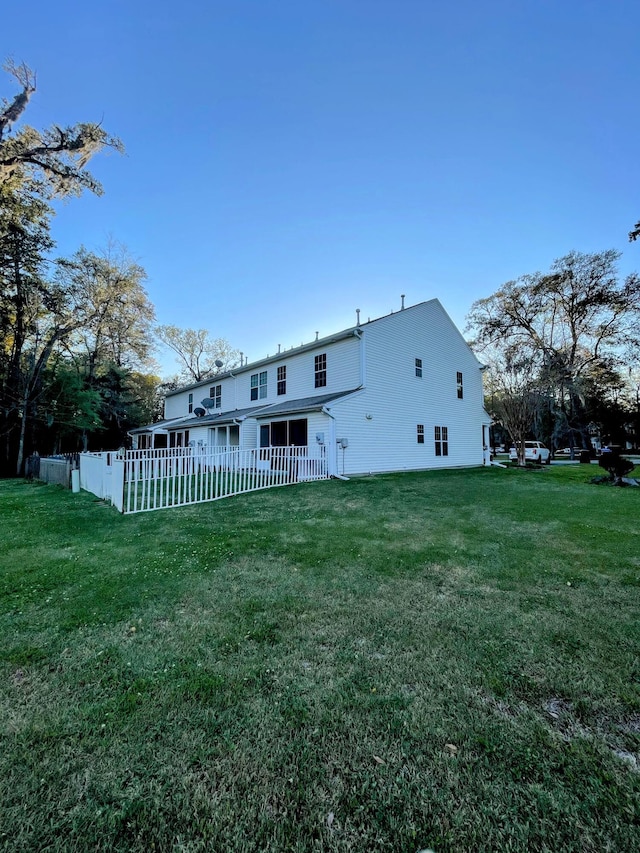 back of house with a lawn