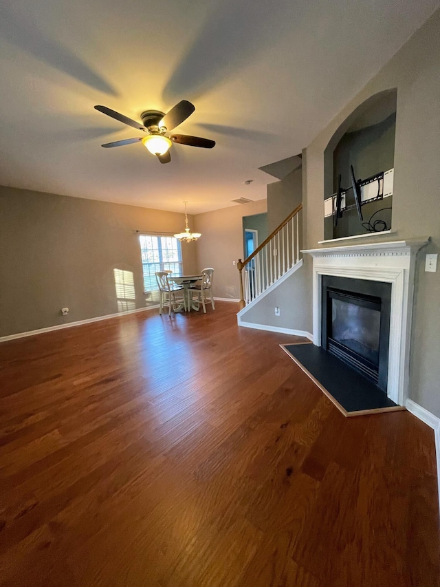 unfurnished living room with ceiling fan and hardwood / wood-style floors