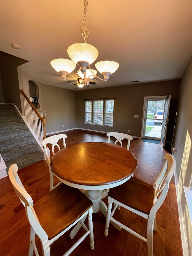 dining space with dark wood-type flooring and plenty of natural light