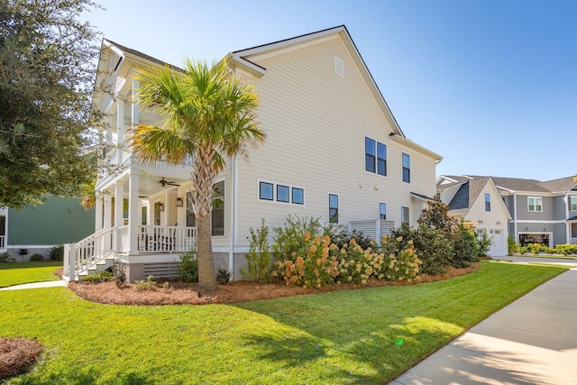 view of property exterior with covered porch and a yard