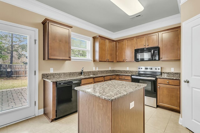 kitchen with visible vents, a center island, ornamental molding, black appliances, and a sink