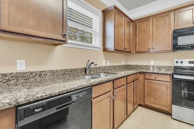 kitchen with light tile patterned floors, black appliances, light stone counters, and a sink