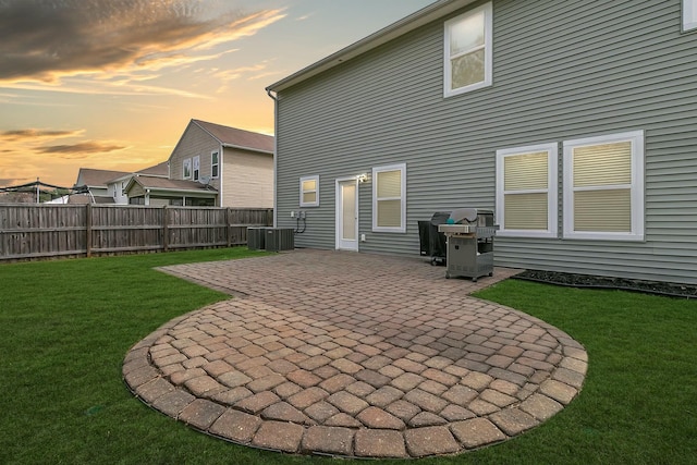 rear view of house featuring a yard, a patio area, and fence