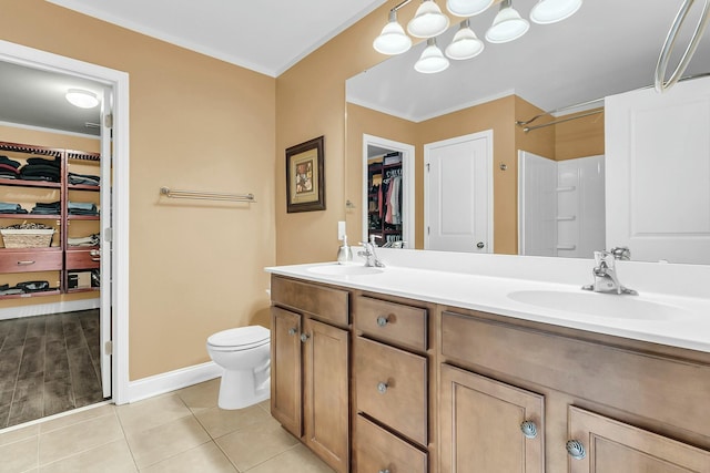 full bathroom with tile patterned flooring, double vanity, toilet, and a sink