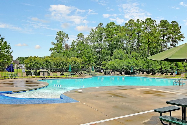 pool featuring a patio and fence