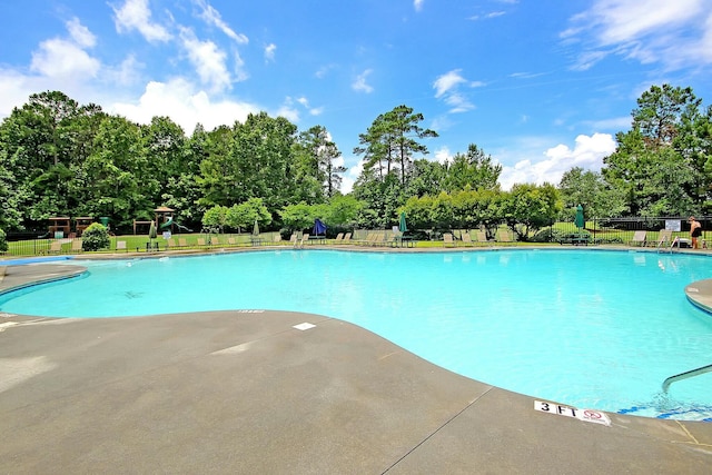 community pool featuring a patio area and fence