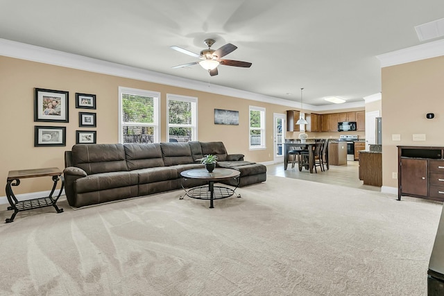 living room featuring visible vents, baseboards, crown molding, and a ceiling fan