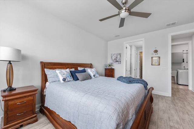 bedroom with ceiling fan, washer / dryer, and light wood-type flooring