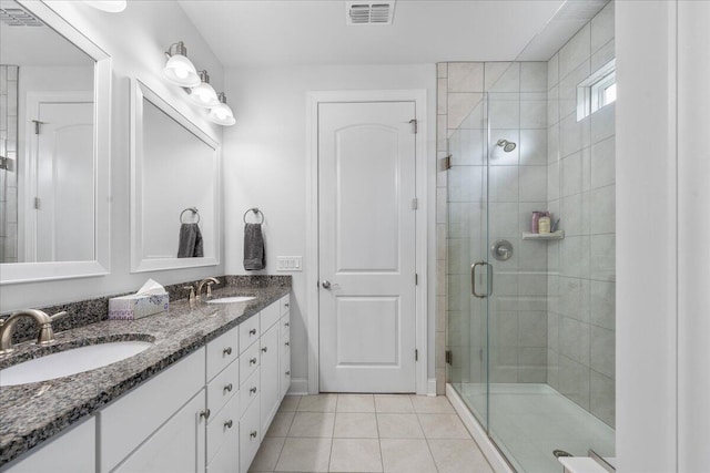 bathroom with walk in shower, tile patterned floors, and vanity