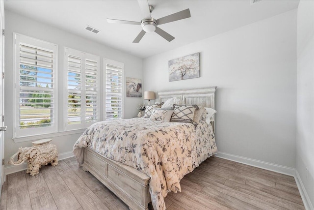 bedroom with light hardwood / wood-style floors and ceiling fan