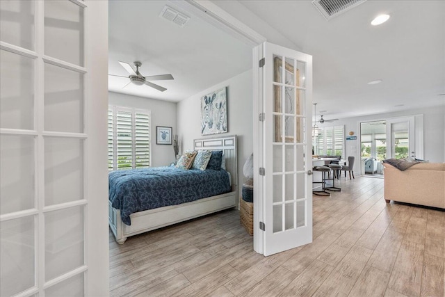 bedroom with light hardwood / wood-style floors, french doors, and ceiling fan