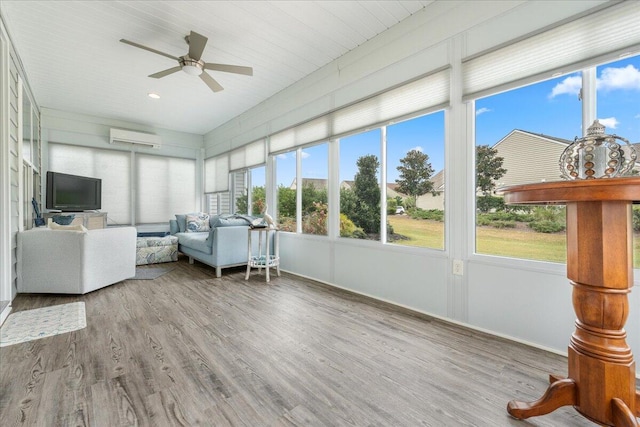 unfurnished sunroom with ceiling fan and a wall unit AC