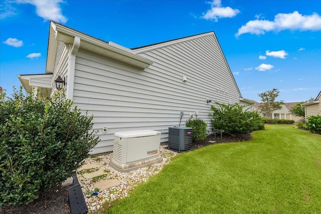 view of home's exterior featuring cooling unit and a lawn