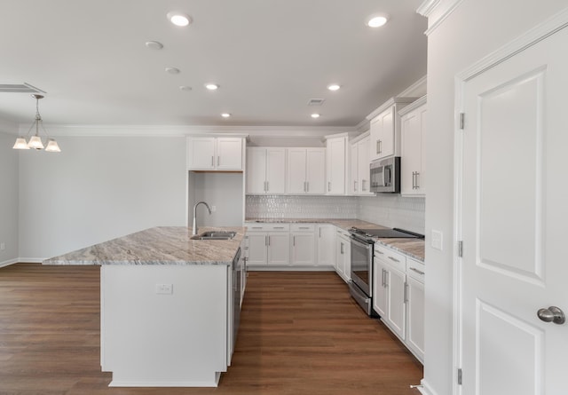 kitchen with white cabinets, appliances with stainless steel finishes, crown molding, and a sink