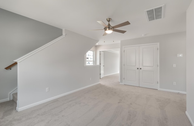 additional living space with a ceiling fan, baseboards, visible vents, carpet floors, and stairs