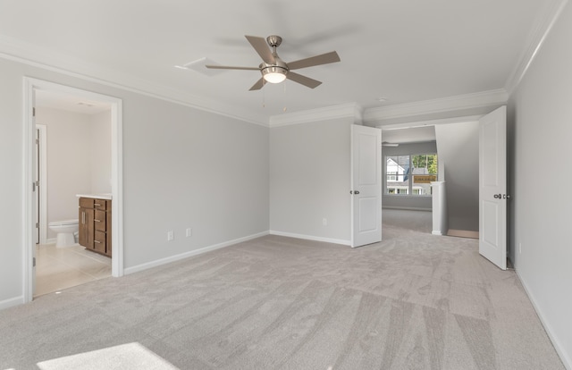 unfurnished bedroom featuring connected bathroom, baseboards, light colored carpet, and crown molding