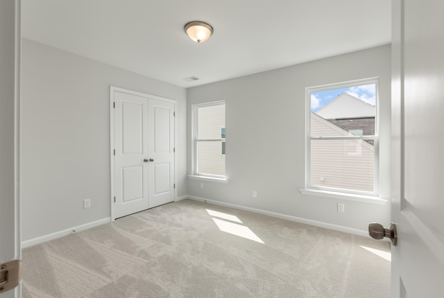 unfurnished bedroom featuring baseboards and carpet