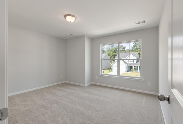 carpeted empty room with baseboards and visible vents