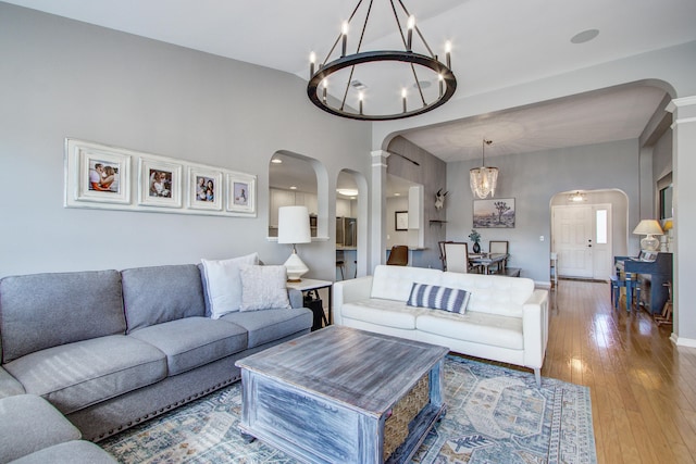 486 Maple Oak Ln, Charleston, SC 29414 - living room featuring arched walkways, a chandelier, wood-type flooring, and decorative columns