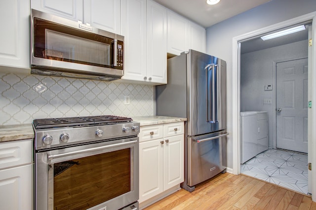 486 Maple Oak Ln, Charleston, SC 29414 - kitchen featuring appliances with stainless steel finishes, white cabinets, light countertops, and light wood-style floors