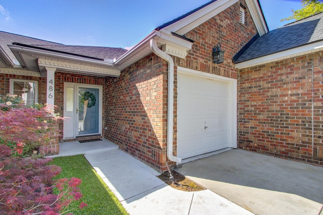 486 Maple Oak Ln, Charleston, SC 29414 - property entrance featuring an attached garage, driveway, roof with shingles, and brick siding