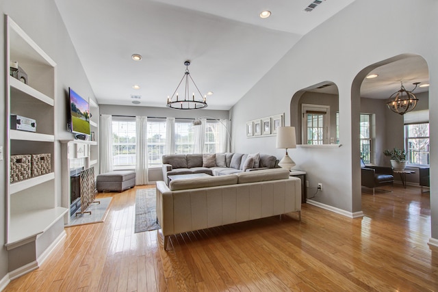 486 Maple Oak Ln, Charleston, SC 29414 - living area featuring a chandelier, arched walkways, healthy amount of natural light, light wood finished floors, and lofted ceiling