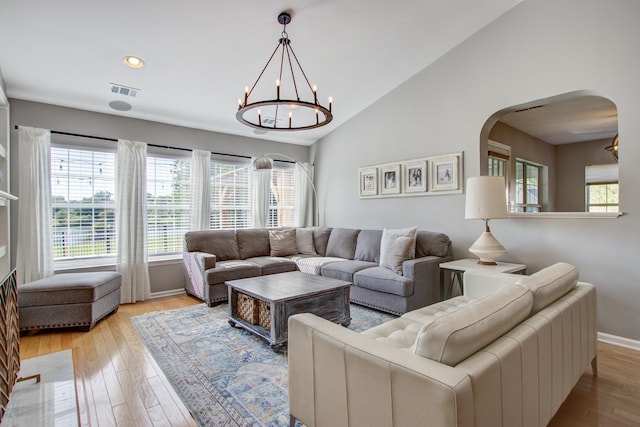 486 Maple Oak Ln, Charleston, SC 29414 - living room featuring arched walkways, light wood-type flooring, lofted ceiling, baseboards, and a chandelier