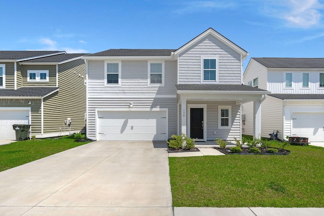 view of front of property with a garage, a front yard, and driveway