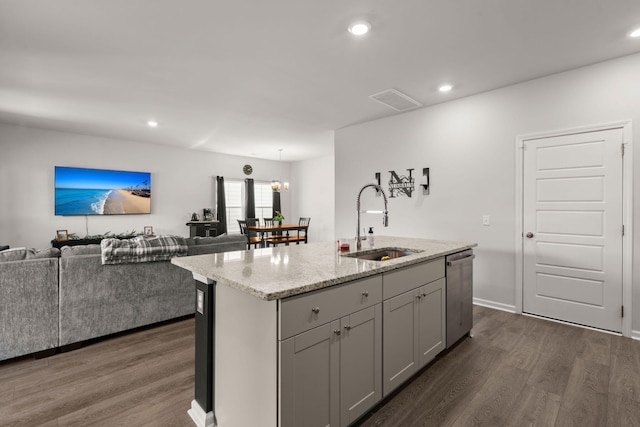 kitchen with a sink, dishwasher, dark wood-style flooring, open floor plan, and recessed lighting