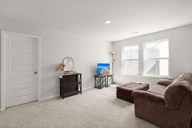 living room featuring carpet flooring and baseboards