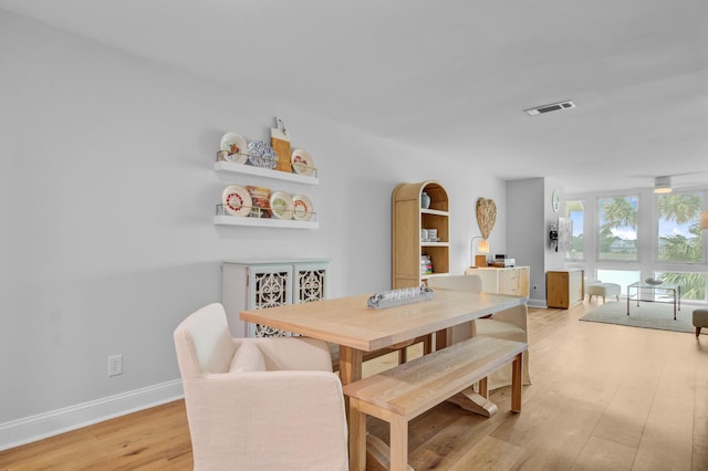 dining room featuring light wood-style floors and baseboards