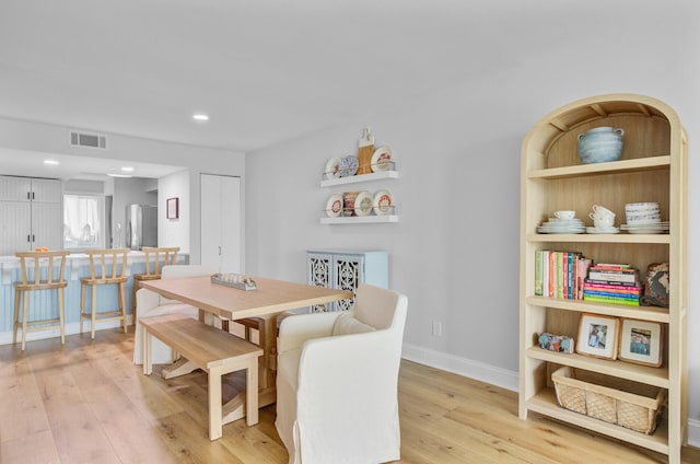dining area featuring light wood-type flooring, baseboards, and recessed lighting