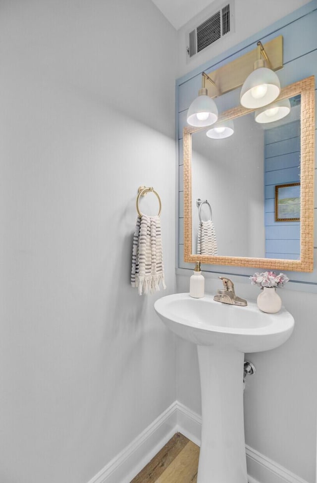 bathroom featuring baseboards and wood finished floors