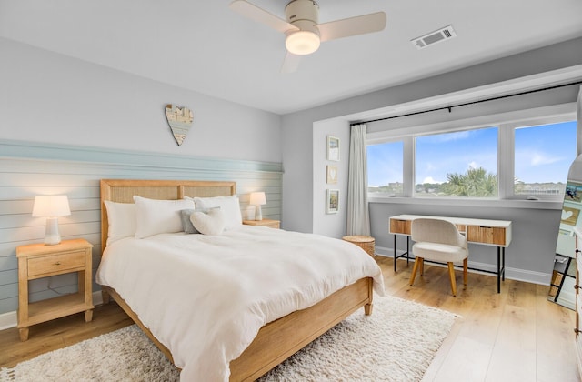 bedroom featuring wood finished floors, baseboards, and a ceiling fan