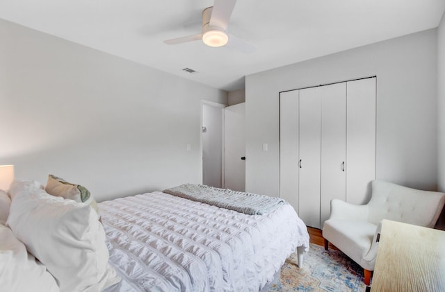 bedroom with wood finished floors, a closet, and a ceiling fan
