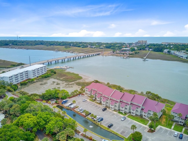 aerial view of a nearby body of water, a notable bridge, and apartment complex / building