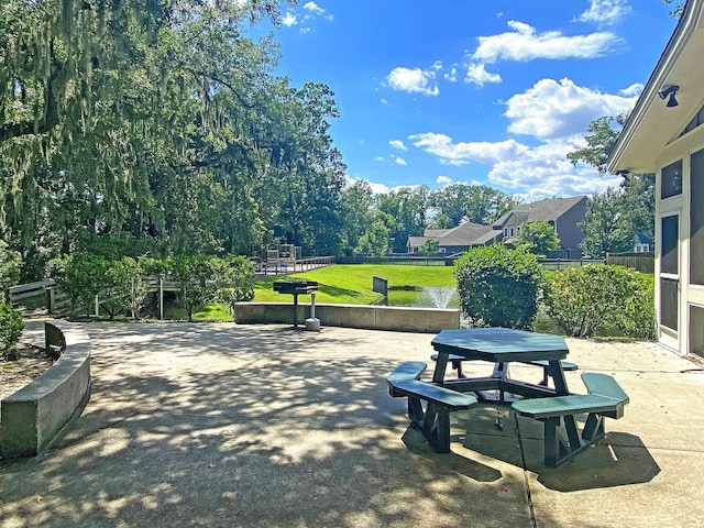 view of community with a patio area, a fenced backyard, outdoor dining area, and a yard