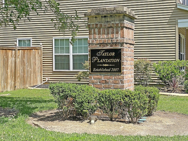 community / neighborhood sign with fence