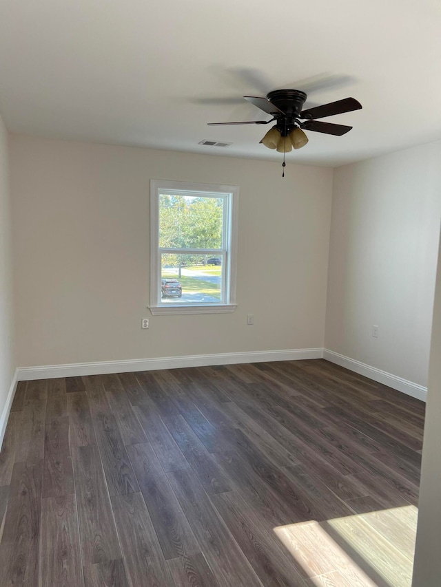 unfurnished room featuring ceiling fan and dark hardwood / wood-style floors