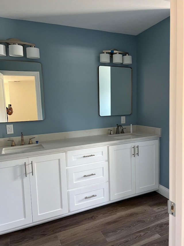 bathroom with hardwood / wood-style floors and vanity