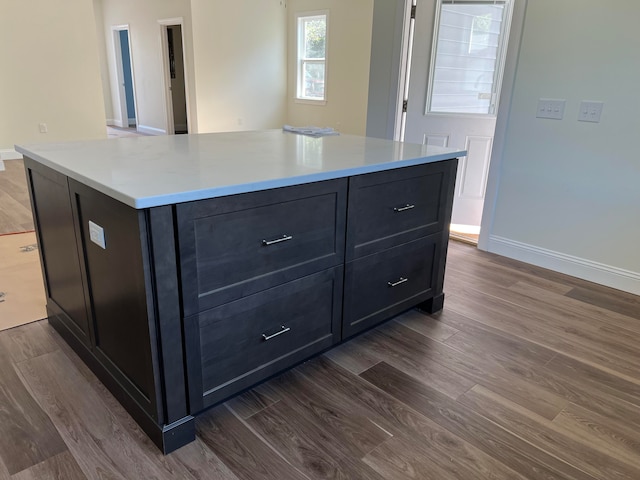 kitchen featuring dark wood-type flooring and a center island