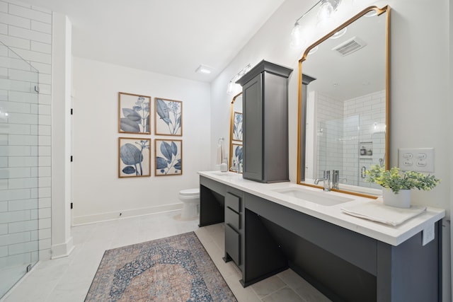 bathroom with tile patterned floors, toilet, a shower with door, and vanity