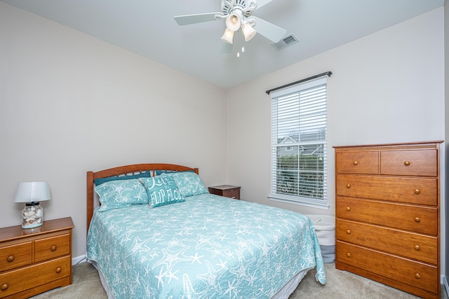 carpeted bedroom featuring visible vents and ceiling fan