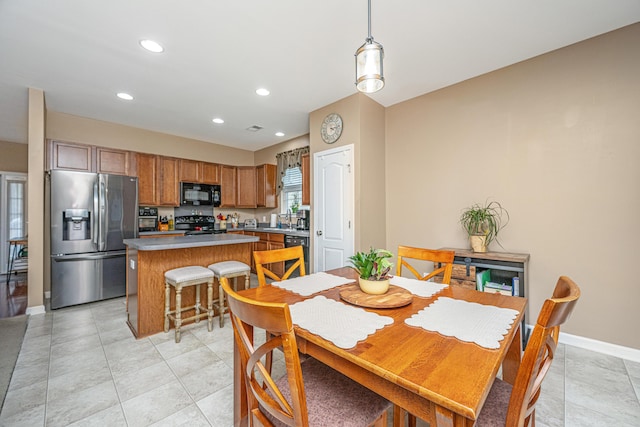 dining area featuring light tile patterned floors, recessed lighting, and baseboards