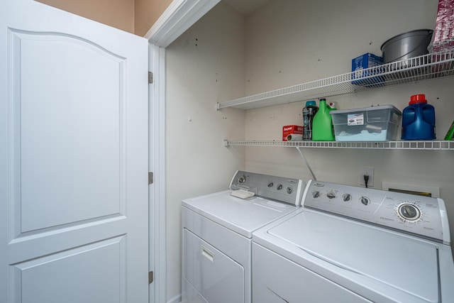 laundry room featuring washing machine and dryer and laundry area